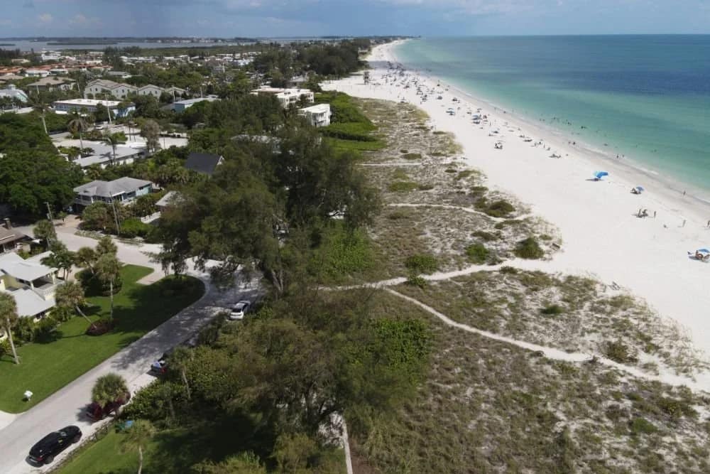 Aerial view of beachfront homes along a Florida beach, representing Palm Beach County real estate closings