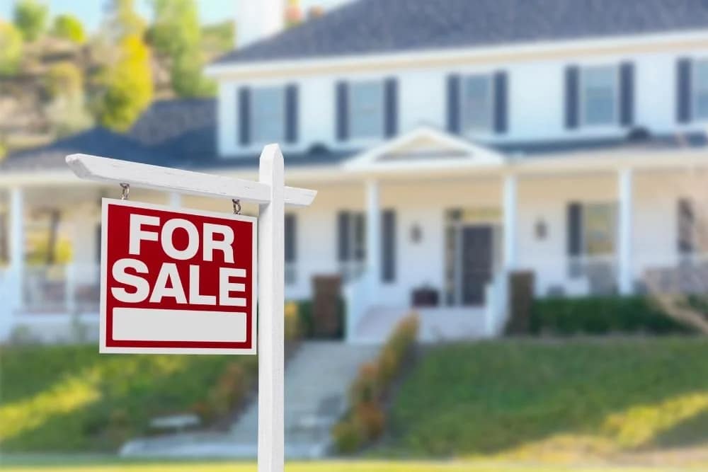 House with for sale sign representing Broward County title insurance and closing customs